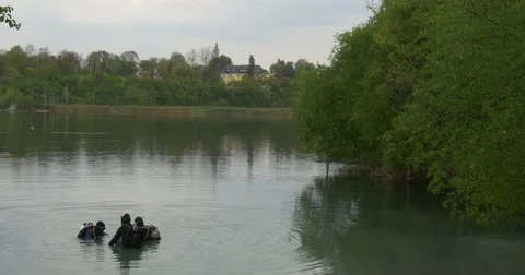 Three Divers Distantly Are Standing in The Water Checking their Equipment Going Stock Footage 55102214