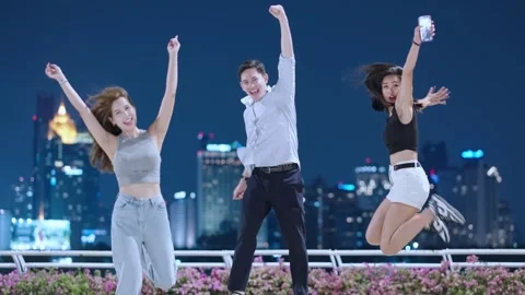Three diverse ethics friends celebrating jumping in front of camera celebrating Stock Footage 276798894