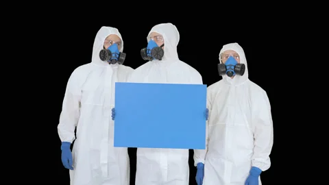 Three doctors in protective suits holding blank board, Alpha Channel Stock-Footage 130646172
