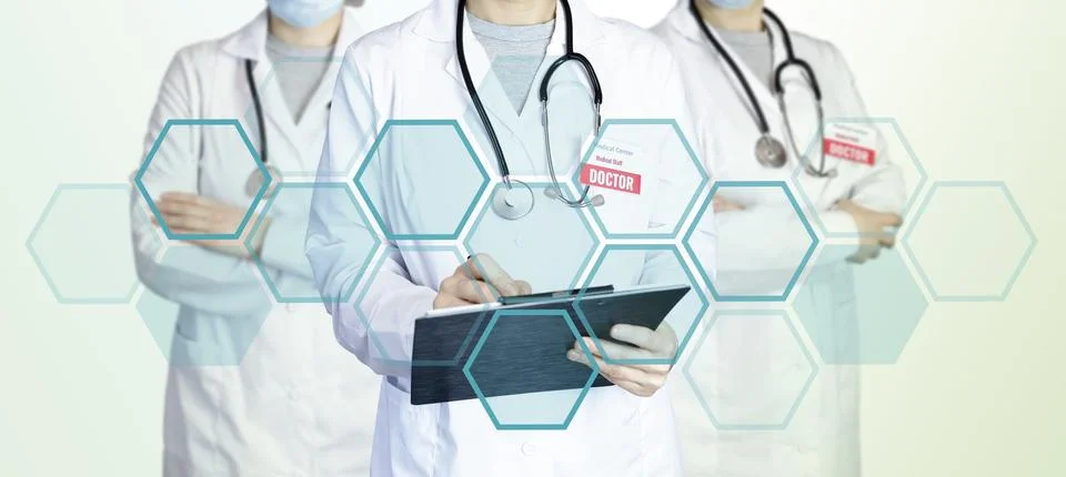 Three doctors stand in a group standing side by side Stock Photos