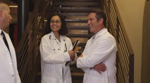 Three doctors talking in hallway Stock Footage 67352139