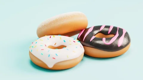 Three donuts on blue background. Chocolate with glazing and colorful sprinkles. Video stock 127304480