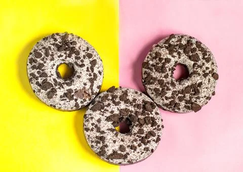 Three donuts on a split colored background Stock Photos