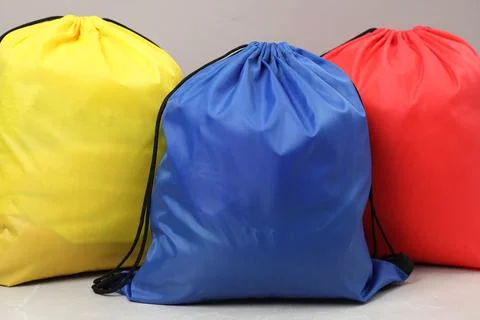Three drawstring bags on light table, closeup Stock Photos