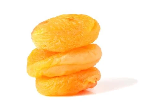 Three dried apricots on the background Stock Photos