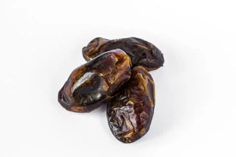 Three dried dates isolated on white Stock-Fotos