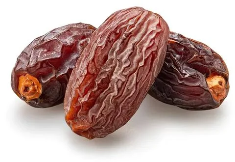 Three dried dates on a white background Stock Photos