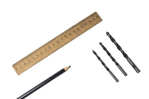 Three drill bit, ruler and pencil on a white background Stock Photos