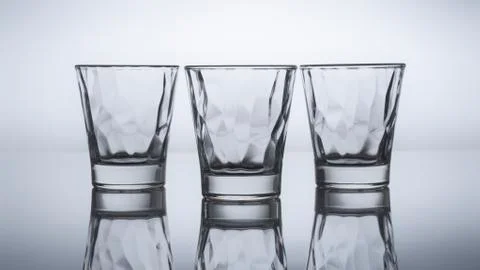 Three drink glasses isolated and reflected Stock Photos