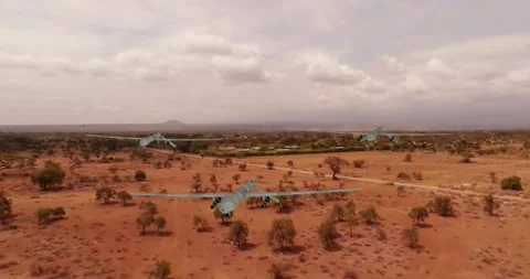 Three drones with rockets under their wings move slowly towards us. Stock Footage 332371863
