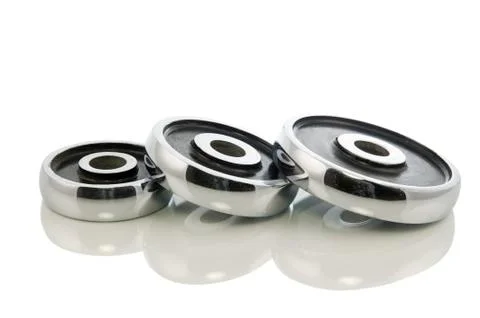 Three dumb-bell weights isolated in white Stock Photos