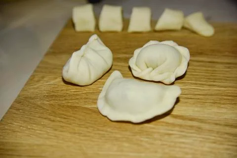 Three dumplings of different shape on the wooden deck. Stock Photos