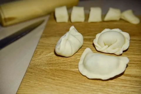 Three dumplings of different shape on the wooden deck. Stock Photos