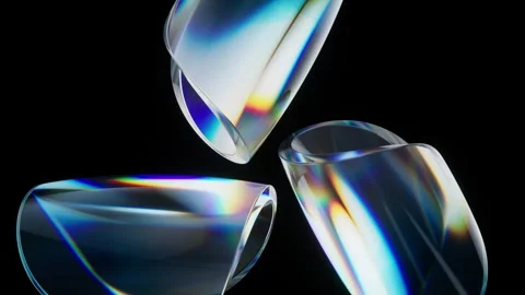 Three dynamically rotating glass elements reflect vibrant colors on a black.. Stock Footage 327345266