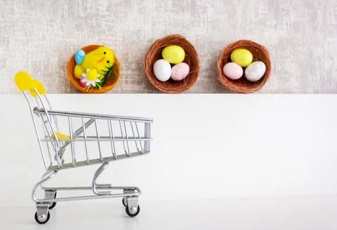 Three Easter baskets with eggs and a cart . Happy Easter. Place for the text Stock Photos