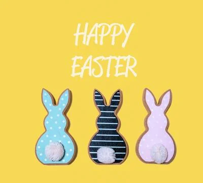 Three Easter bunnies with pom poms on their tails Stock Photos