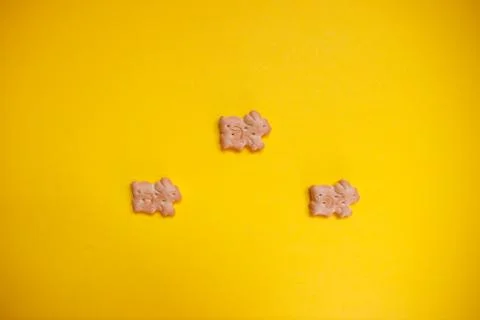 Three easter bunny cookies on yellow background separated Stock Photos