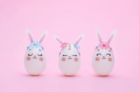 Three Easter Bunny eggs on a pink background. Фото