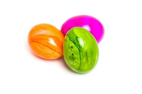 Three Easter colored eggs. Green egg in the foreground. Isolated Stock Photos
