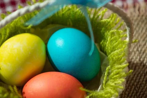Three Easter eggs in a basket Stock Photos
