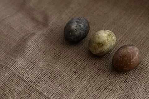 Three easter eggs on a burlap texture Stock Photos