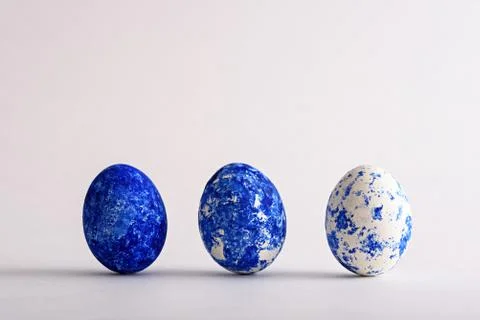 Three Easter eggs in the color of the year-classic blue with gradient effect  Stock Photos