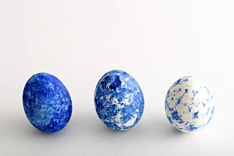 Three Easter eggs in color of the year-classic blue with gradient effect on w Stock Photos