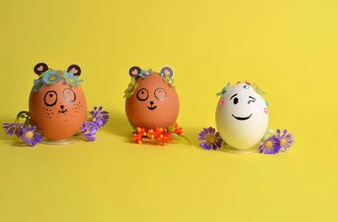 Three Easter eggs with flowers on a yellow background. Spring. Easter. Stock Photos