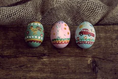 Three easter eggs on a wooden board Stock Photos