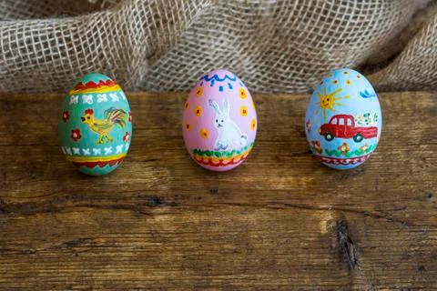 Three easter eggs on a wooden board Stock Photos