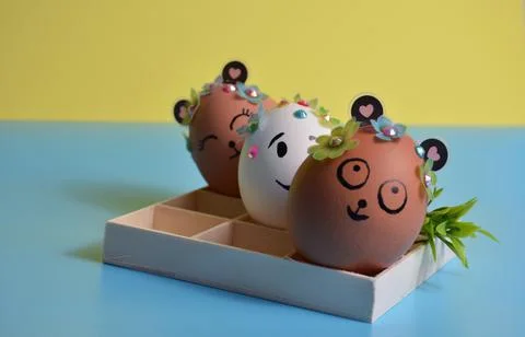 Three Easter eggs on a yellow-blue background. Easter. Stock Photos