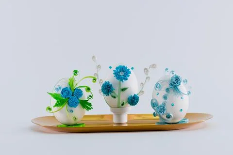 Three Easter eggs on a yellow tray decorated with quilling Stock Photos