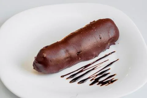 Three eclairs with chocolate isolated on white background. Top view Stock Photos