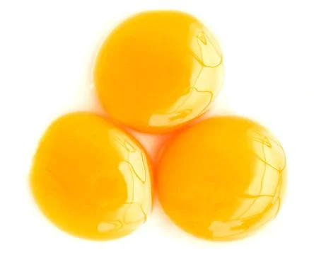 Three egg yolk closeup Stock Photos