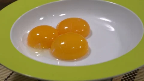 Three egg yolks in a spinning dish Stock-Footage 88042652