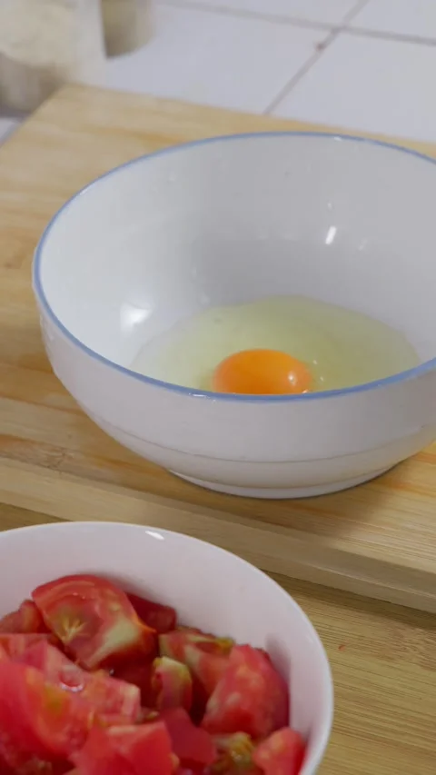 Three eggs are cracked into a bowl. Preparation before scrambled eggs. Stock Footage 341306879