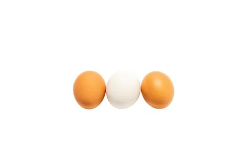 Three eggs are shown in a row, with one white and two brown Stock Illustration