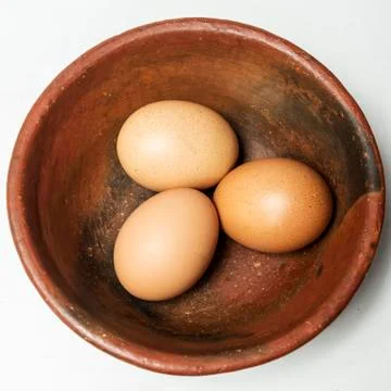 Three eggs in a bowl Stock Photos
