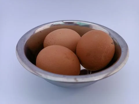 Three eggs in a bowl Stock Photos