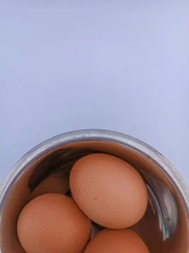 Three eggs in a bowl Stock Photos