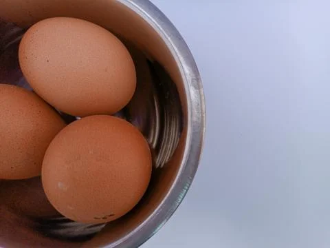 Three eggs in a bowl Stock Photos