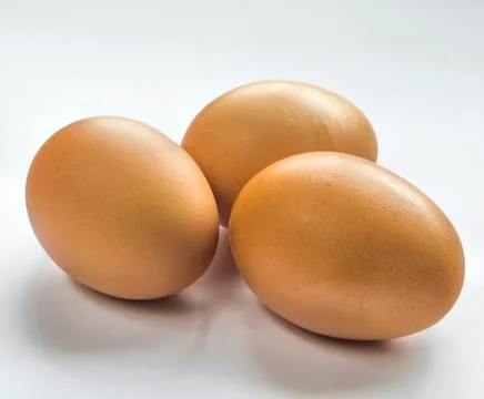 Three eggs isolated on white background with warm shadow Stock Photos