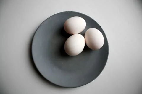 Three eggs on plate Stock Photos