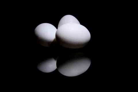 Three eggs with reflection Stock Photos