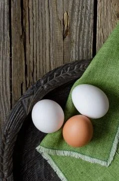 Three eggs in a rustic bowl Stock Photos