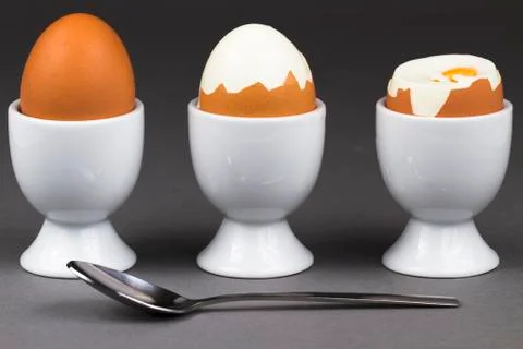 Three eggs with spoon Stock Photos