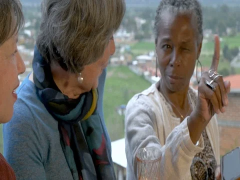 Three elderly senior woman in their 60s laughing and talking and telling stories Stock Footage 80970583