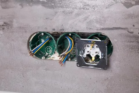 Three electrical boxes for conduits are built into the wall. Work on instal.. Stock Photos