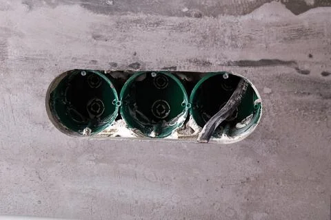 Three electrical boxes for conduits are built into the wall. Work on instal.. Stock-Fotos