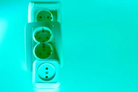 Three electrical double socket for connecting devices in green light Stock Photos
